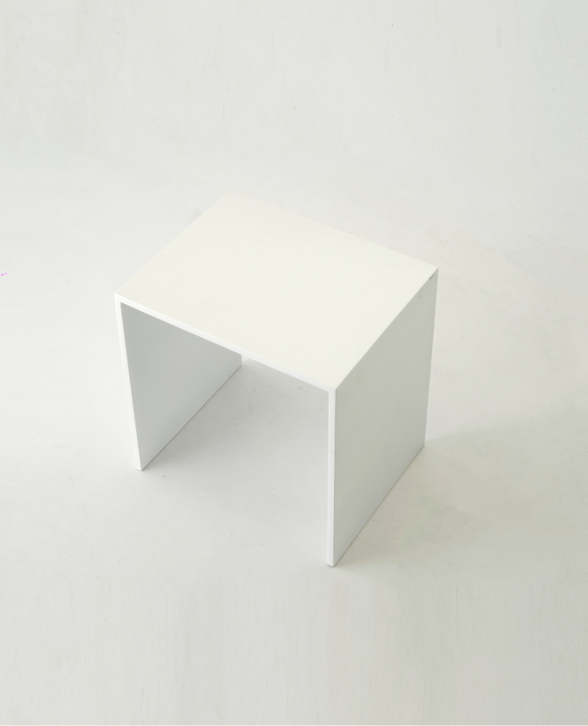 A minimalist white side table with a thin rectangular top and two straight legs, all with even thickness.